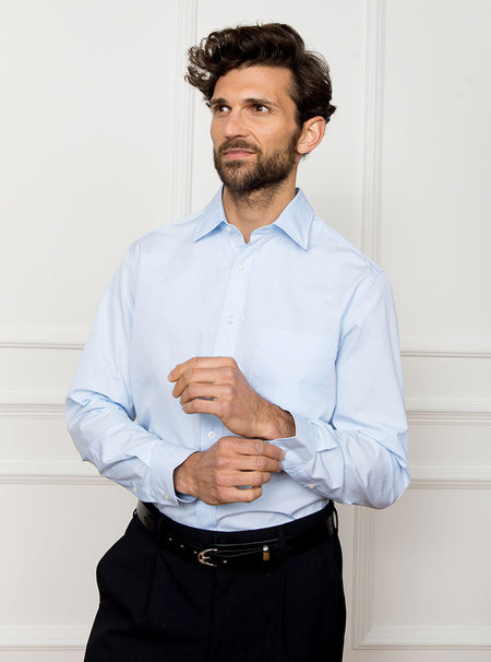 Man wearing sky blue long sleeved shirt made with 100% Royal Oxford Cotton.